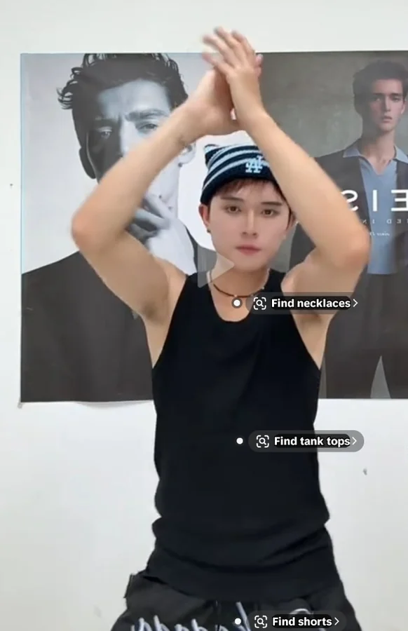 Aaron dancing in black sleeveless top