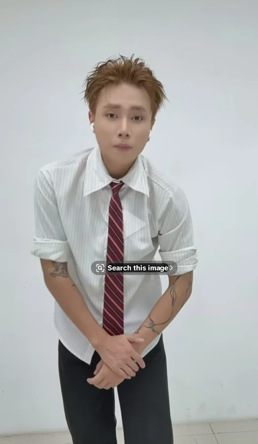 ice in white collared shirt and red tie