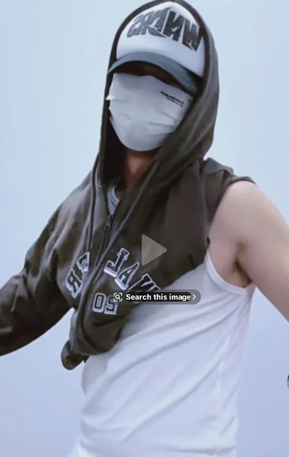 prince in a white tank and face mask with cap